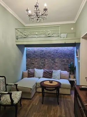 a living room with a couch and a table at Studio Suzi in Belgrade