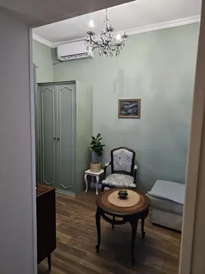 a living room with a table and a chair at Studio Suzi in Belgrade