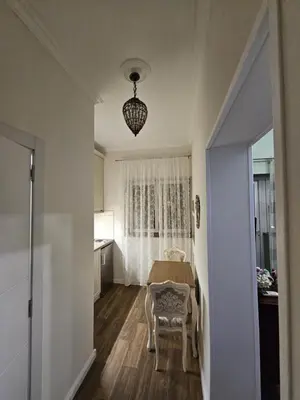 a room with a table and a kitchen with a window at Studio Suzi in Belgrade