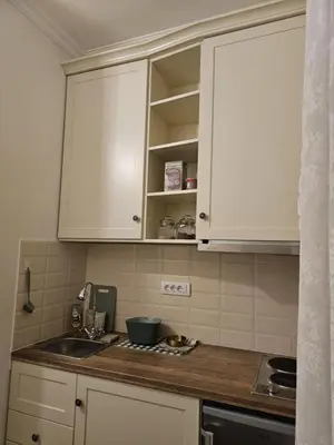 a kitchen with white cabinets and a sink at Studio Suzi in Belgrade
