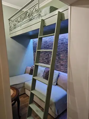 a bunk bed in a room with a ladder at Studio Suzi in Belgrade