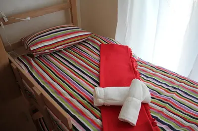 a bed with a stuffed animal on top of it at Guest House Miss Depolo in Belgrade