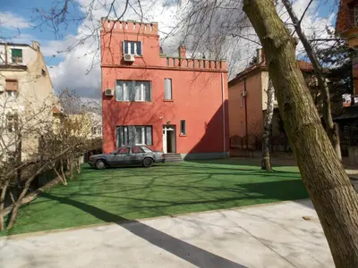 a house with a car parked in front of it at Guest House Miss Depolo in Belgrade