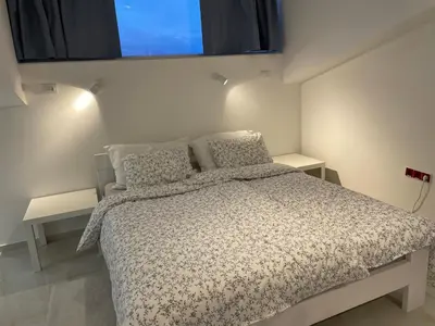a bedroom with a bed and two night stands at Golden Gate 21 in Ruma