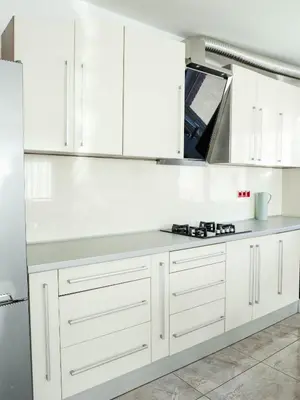 a kitchen with white cabinets and a counter top at Golden Gate 21 in Ruma