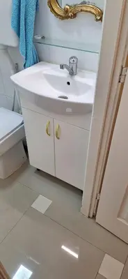 a white bathroom with a sink and a mirror at Dream apartment Beograd in Belgrade