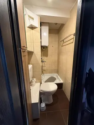 a small bathroom with a toilet and a bath tub at Bann1 in Belgrade