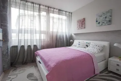 a bedroom with a pink bed and a window at Apartments Tom&Jerry in Belgrade