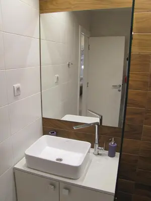 a bathroom with a white sink and a mirror at Apartments Tom&Jerry in Belgrade