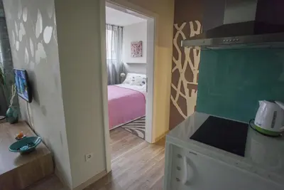 a small room with a bedroom with a bed at Apartments Tom&Jerry in Belgrade