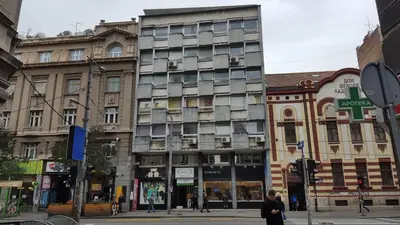 a tall building on a city street with buildings at Apartments Tom&Jerry in Belgrade