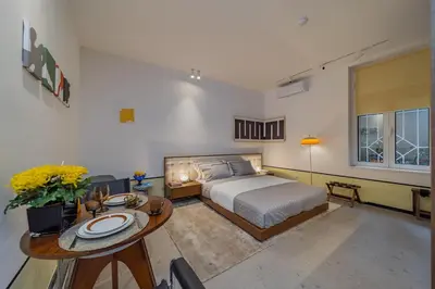 a bedroom with a bed and a table with plates on it at Chic NEW IvoLola Studio YU modern design gem in Belgrade