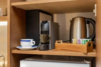 a coffee maker on a shelf in a kitchen at Chic NEW IvoLola Studio YU modern design gem in Belgrade