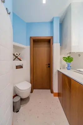 a bathroom with a toilet and a wooden door at Chic NEW IvoLola Studio YU modern design gem in Belgrade