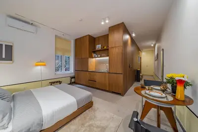 a bedroom with a large bed and a table at Chic NEW IvoLola Studio YU modern design gem in Belgrade