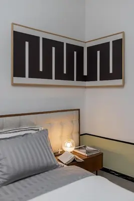 a bedroom with a bed and a table with a lamp at Chic NEW IvoLola Studio YU modern design gem in Belgrade