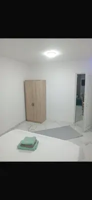 a white room with a green towel on the floor at melvina 3 in Pančevo