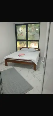 a bed in a room with a window and a bedvisor at melvina 3 in Pančevo