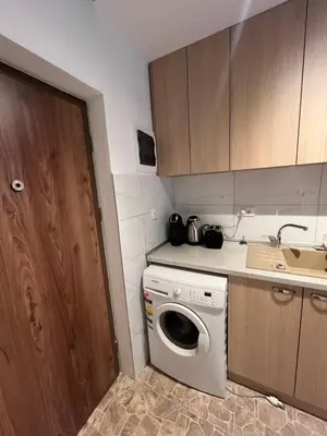 a kitchen with a washing machine and a sink at Pariske komune in Belgrade