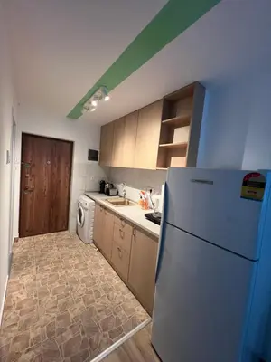 a kitchen with a white refrigerator and a stove at Pariske komune in Belgrade