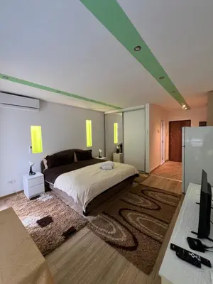 a bedroom with a large bed and a desk at Pariske komune in Belgrade