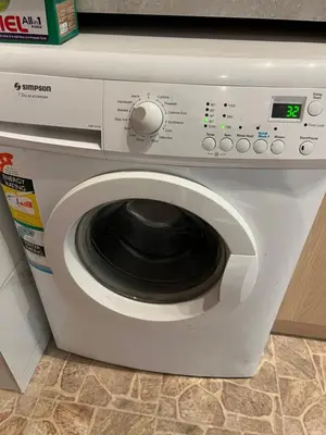 a white washing machine sitting in a kitchen at Pariske komune in Belgrade