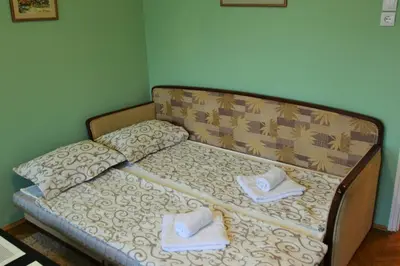 a bed with two towels on top of it at LC Cozy Studio in Belgrade
