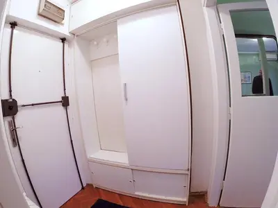 a closet with two doors and a mirror at LC Cozy Studio in Belgrade