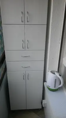 a white cabinet with a toaster on top of it at LC Cozy Studio in Belgrade