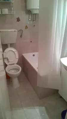 a bathroom with a toilet and a bath tub at LC Cozy Studio in Belgrade