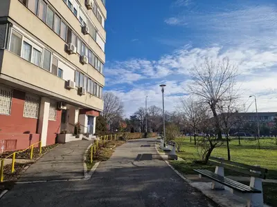 a street with benches in front of a building at Royal apartment Novi Mercator in Belgrade