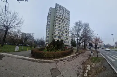 a tall building on the side of a street at Royal apartment Novi Mercator in Belgrade