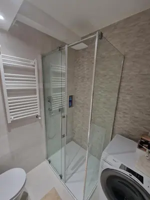 a shower in a bathroom with a toilet and a sink at Royal apartment Novi Mercator in Belgrade