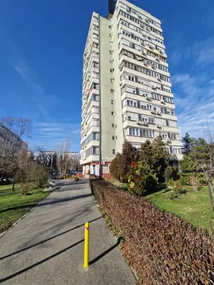 a tall white apartment building on a street at Royal apartment Novi Mercator in Belgrade