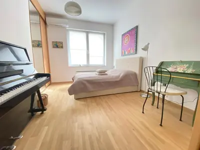 a room with a piano and a bed in it at City center salon-style apartment free parking in Belgrade