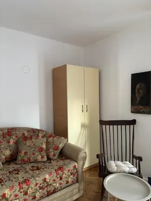 a living room with a couch and a table and a cabinet at Apartmani IDILA in Smederevo
