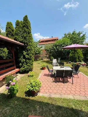 a patio with a table and an umbrella at Apartmani IDILA in Smederevo