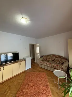 a living room with a couch and a flat screen tv at Apartmani IDILA in Smederevo