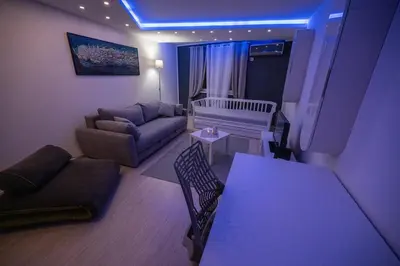 a living room with a couch and a table at Dove's Nook - A Stylish City Center Retreat in Belgrade