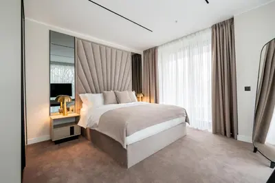 a bedroom with a large bed and a large window at New Belgrade Premium Hotel in Belgrade