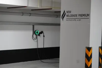 a parking garage with a green light on a wall at New Belgrade Premium Hotel in Belgrade