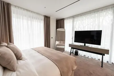 a bedroom with a bed and a flat screen tv at New Belgrade Premium Hotel in Belgrade