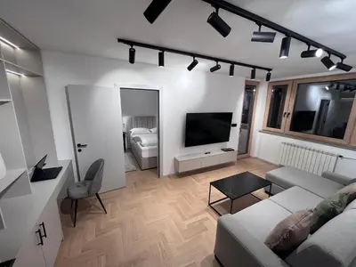 a living room with a couch and a tv at Urban Central Oasis in Belgrade