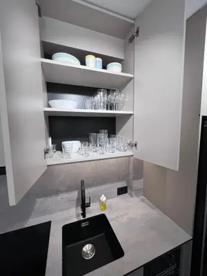 a kitchen with a sink and a shelf with glasses at Urban Central Oasis in Belgrade