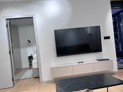a living room with a large flat screen tv on a wall at Urban Central Oasis in Belgrade