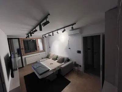a living room with a couch and a table at Urban Central Oasis in Belgrade