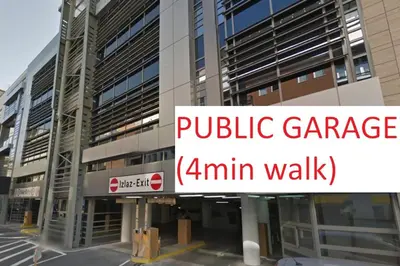 a building with a sign that reads public garage walk at Urban Central Oasis in Belgrade
