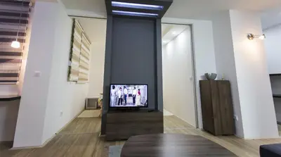 a living room with a tv on a wall at Apartment Nevena in Belgrade