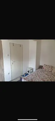 a bedroom with a bed and a white cabinet at Apartman- Ledine in Ledine