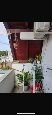 a balcony with potted plants on a building at Apartman- Ledine in Ledine